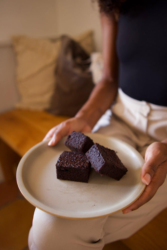 
                  
                    Person holding Black Bean Brownies on a plate
                  
                